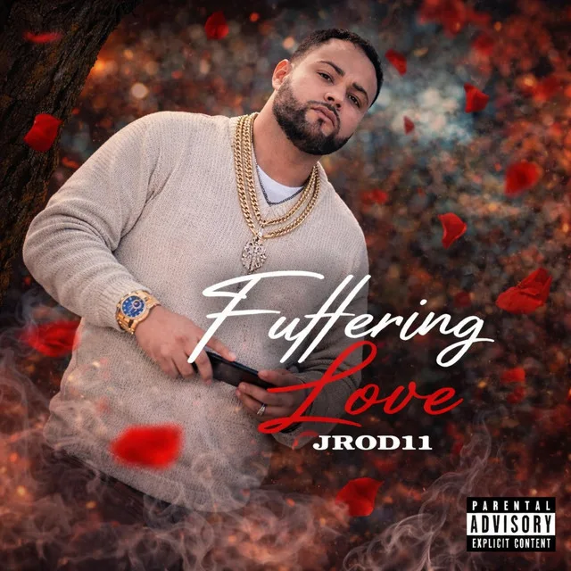 “Buffering Love” cover art — JC in a cream sweater and a gold chain as red petals fall around him